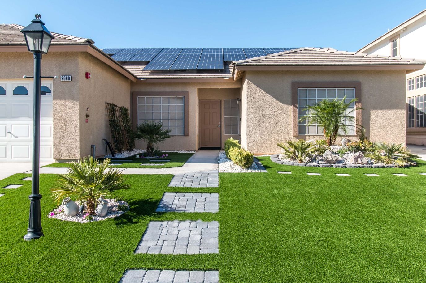 Front exterior of a senior living facility with landscaped garden