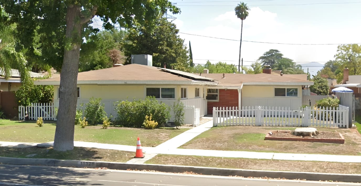 Exterior view of a senior care facility with a garden