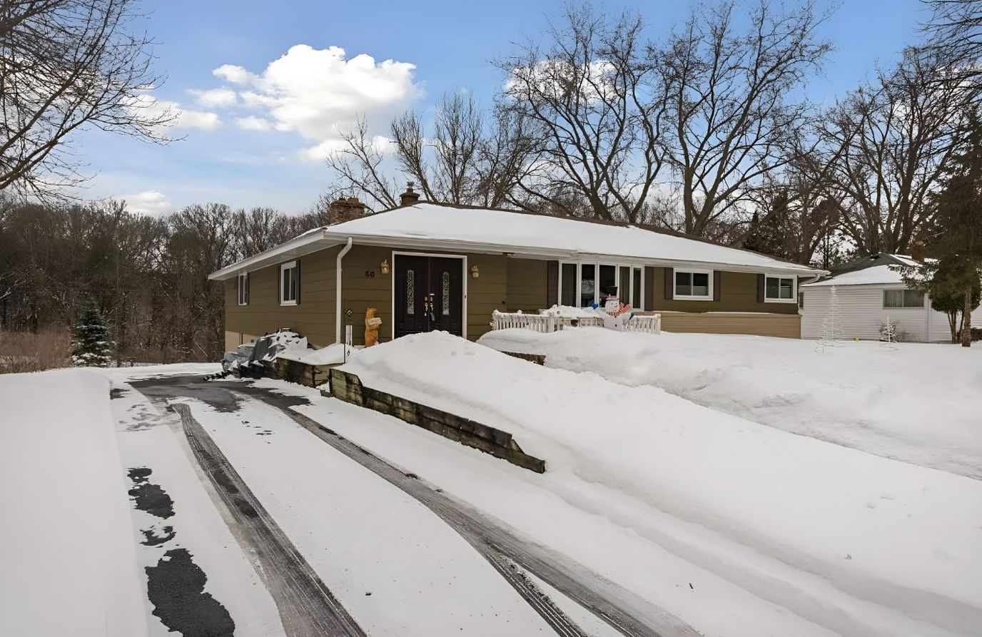 Exterior view of a senior living facility covered in snow