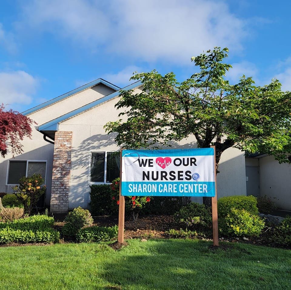 Exterior view of Sharon Care Center with sign