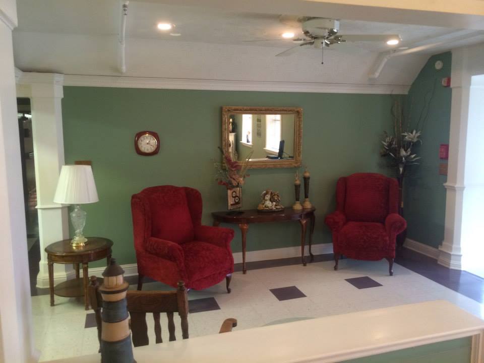 Bright common area with red armchairs and decor