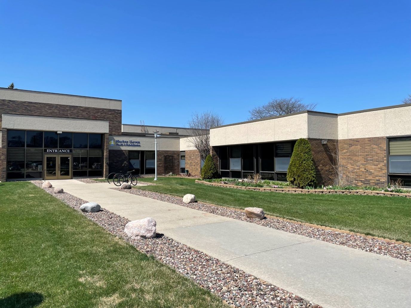 Building entrance with landscaping and blue sky