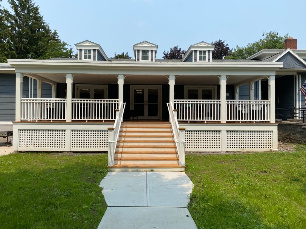 Front entrance of a senior living facility with a porch