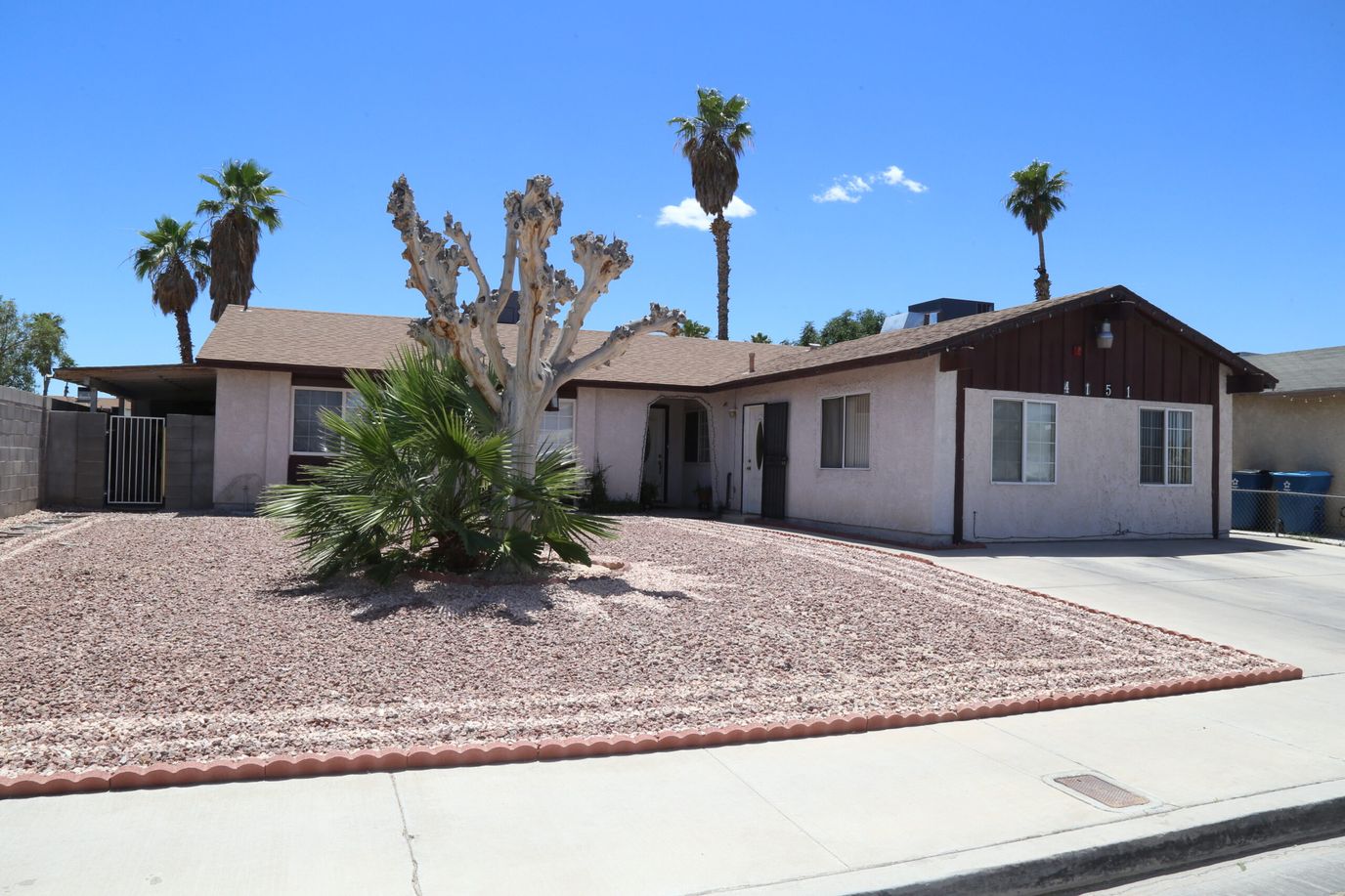 Exterior of a residential care home with palm trees