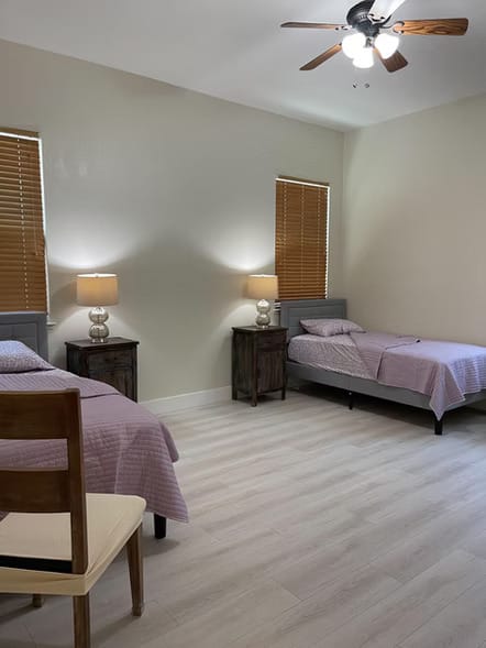 Private resident room with two beds and lamps