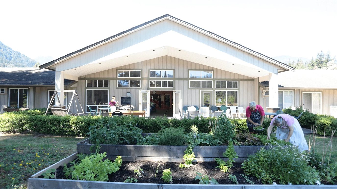Residents gardening in front of the facility