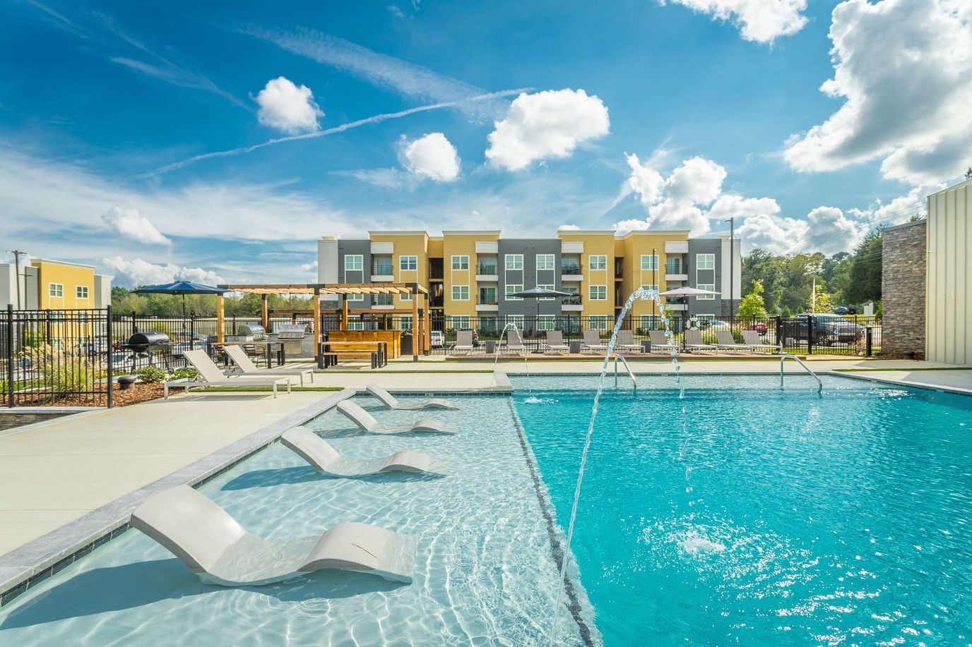 Outdoor swimming pool area with lounge chairs
