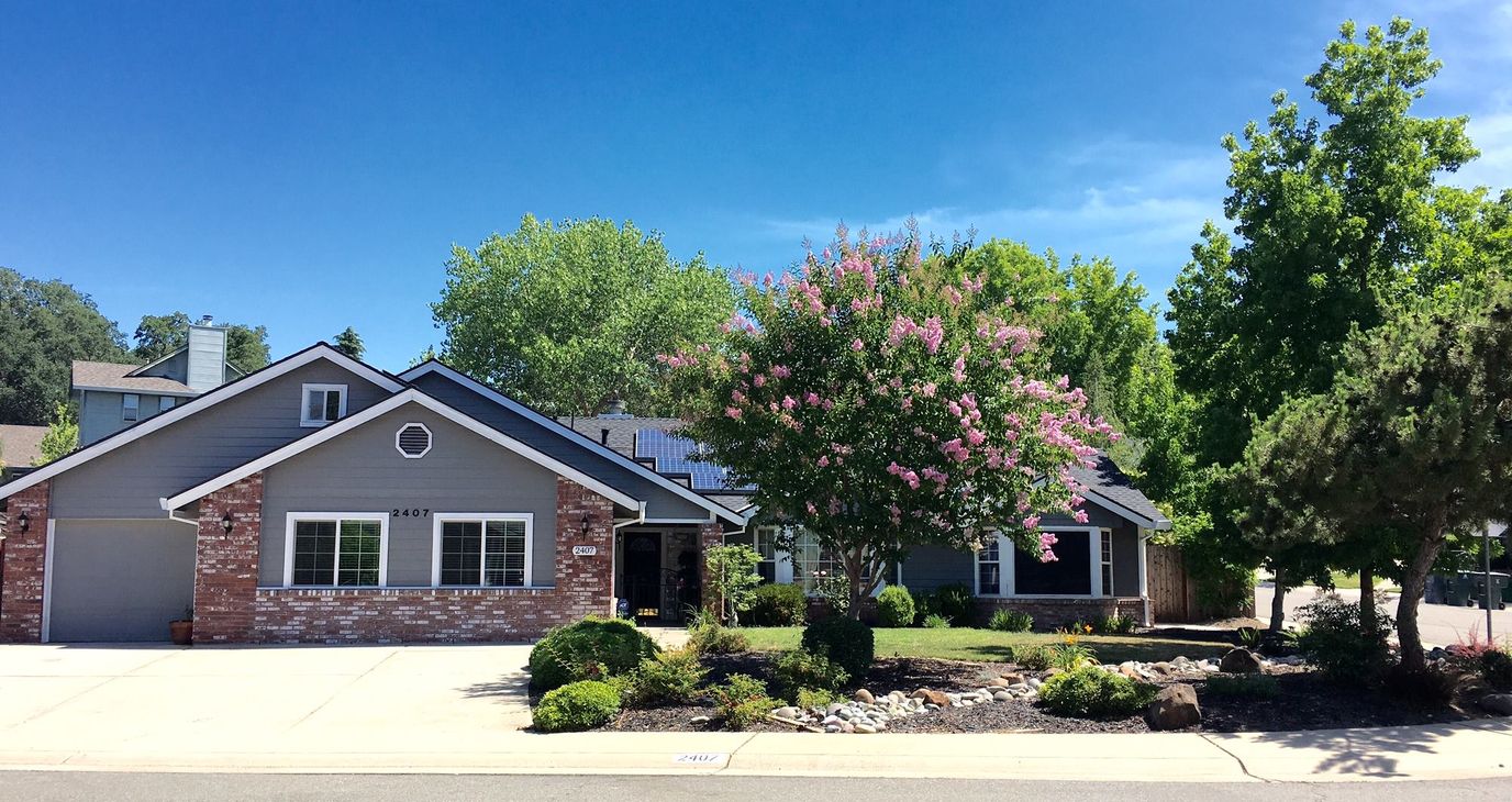 Exterior view of a senior living facility with landscaping