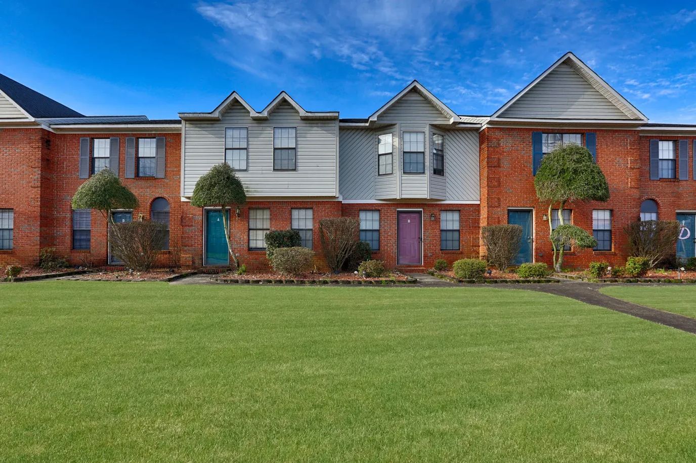 Exterior view of Huntington Place Townhomes with landscaping