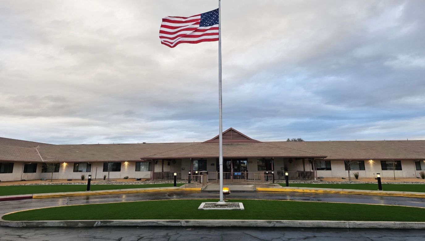 Exterior view of the nursing facility with an American flag