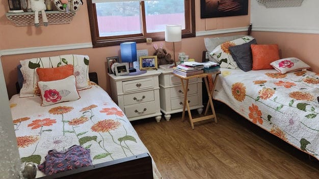 Cozy shared resident room with two beds and decorations
