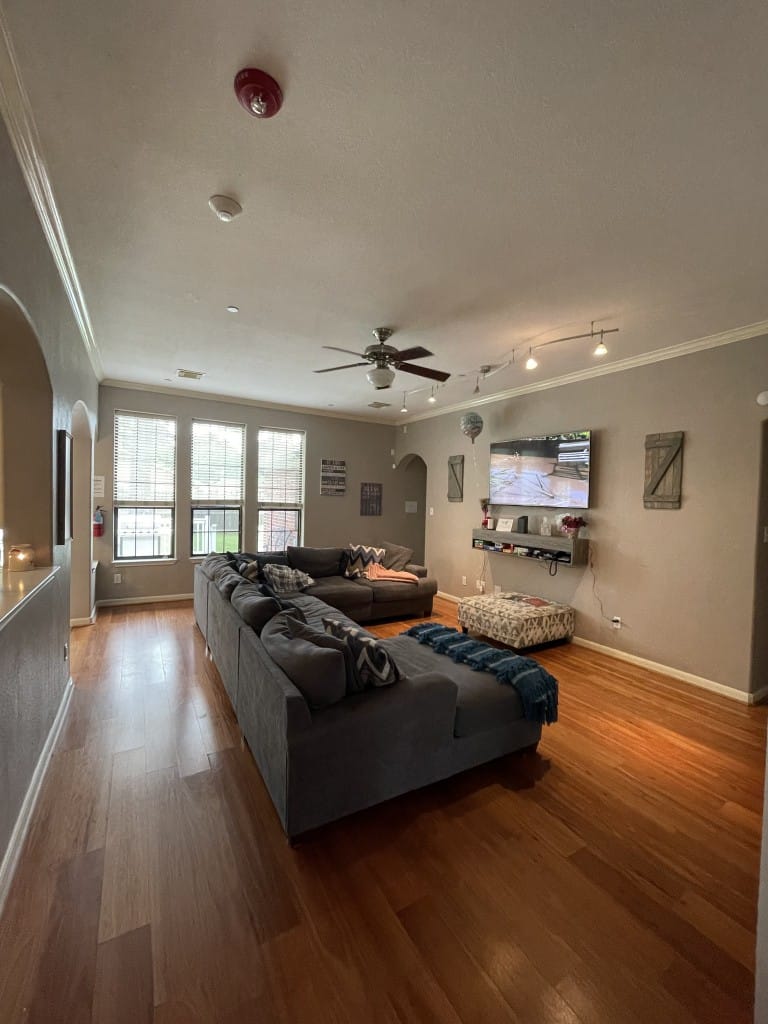 Bright common area with seating and a TV