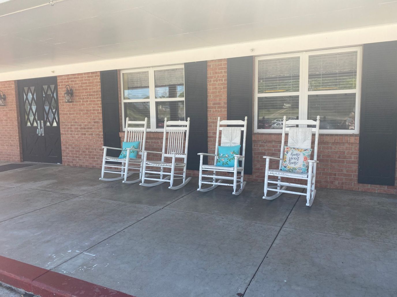 Rocking chairs on a porch outside the facility