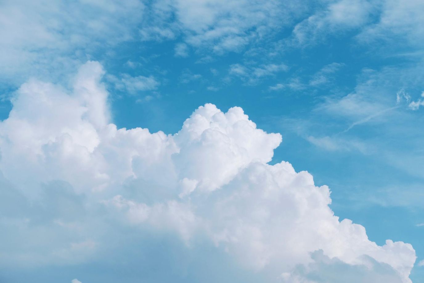 Fluffy white clouds against a blue sky