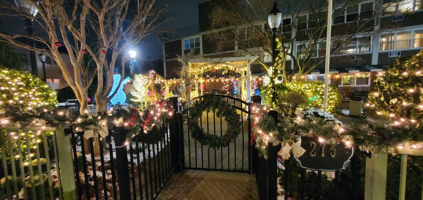 Decorated outdoor area with lights and wreaths