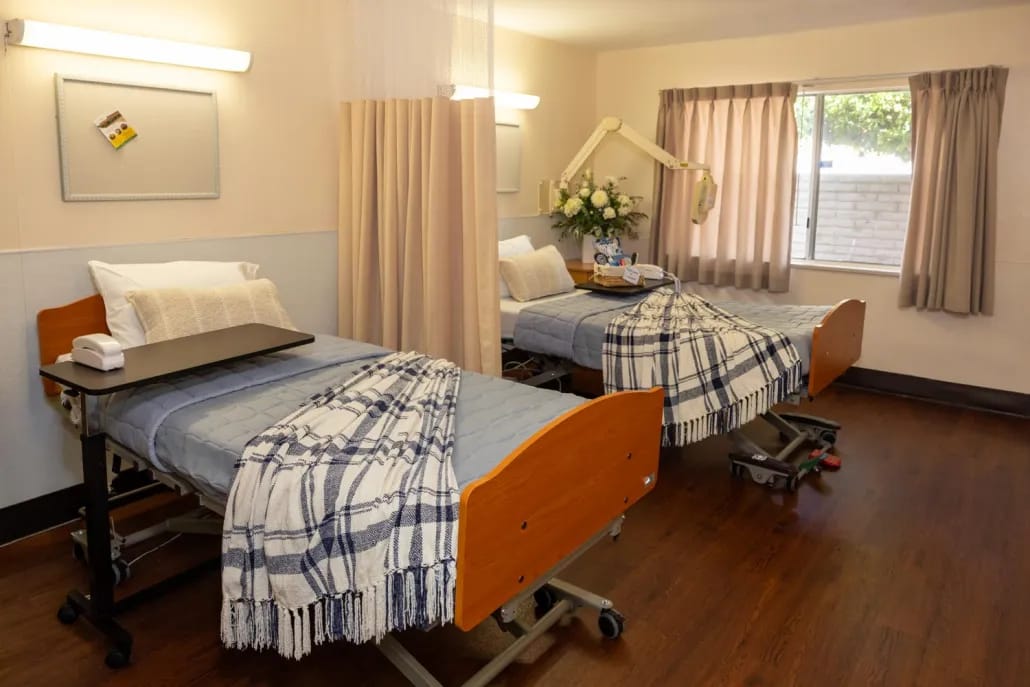 Two beds in a well-lit resident room
