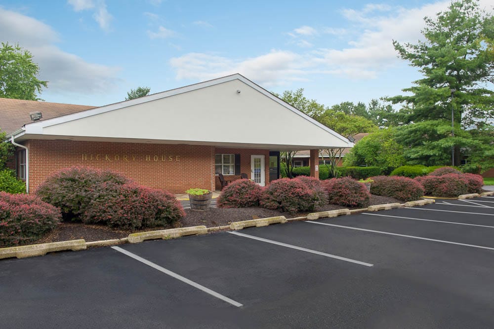 Exterior view of Hickory House Nursing Home with landscaped entrance