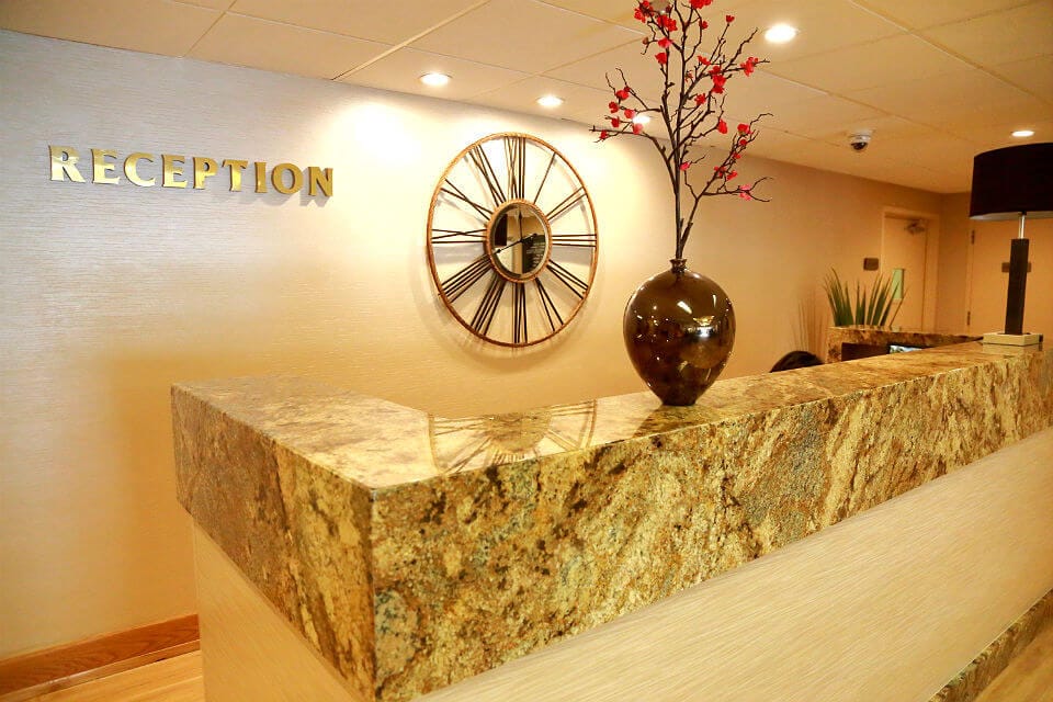 Reception area with a clock and decorative vase
