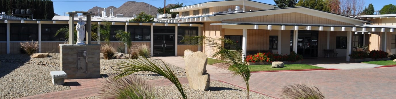 Exterior view of the facility building with landscaped garden