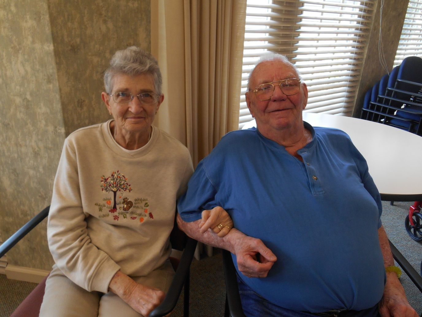Two residents enjoying each other's company in a common area.
