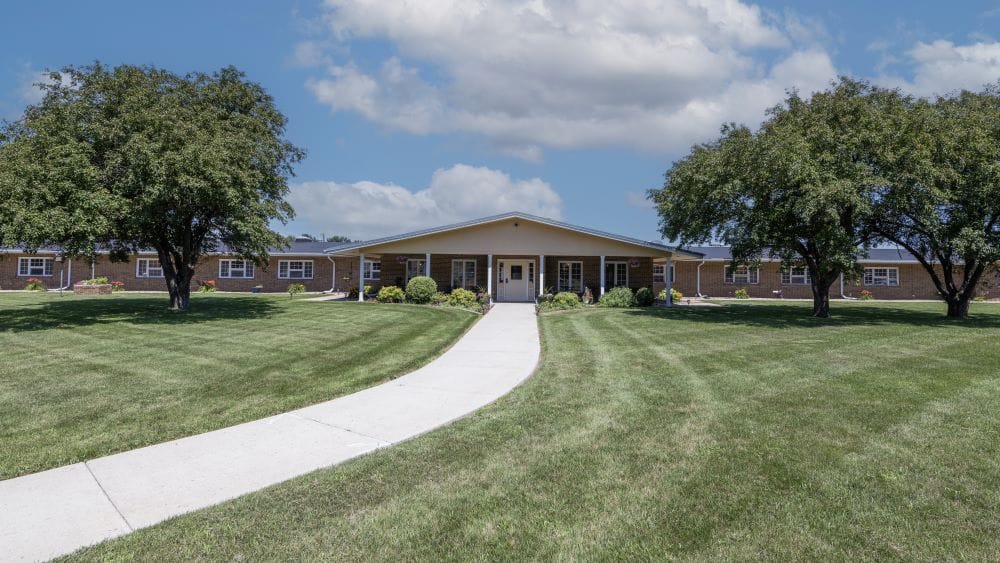 Exterior view of Palisade Healthcare Center with landscaped grounds