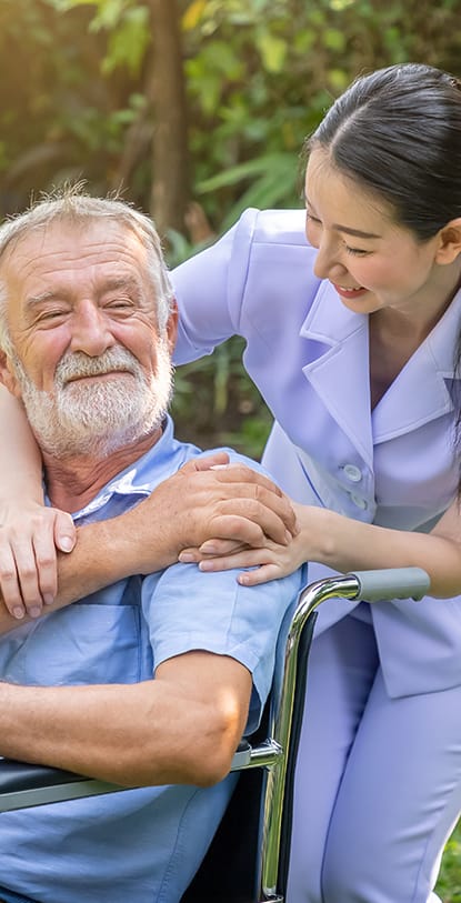 Nurse assisting a resident outdoors