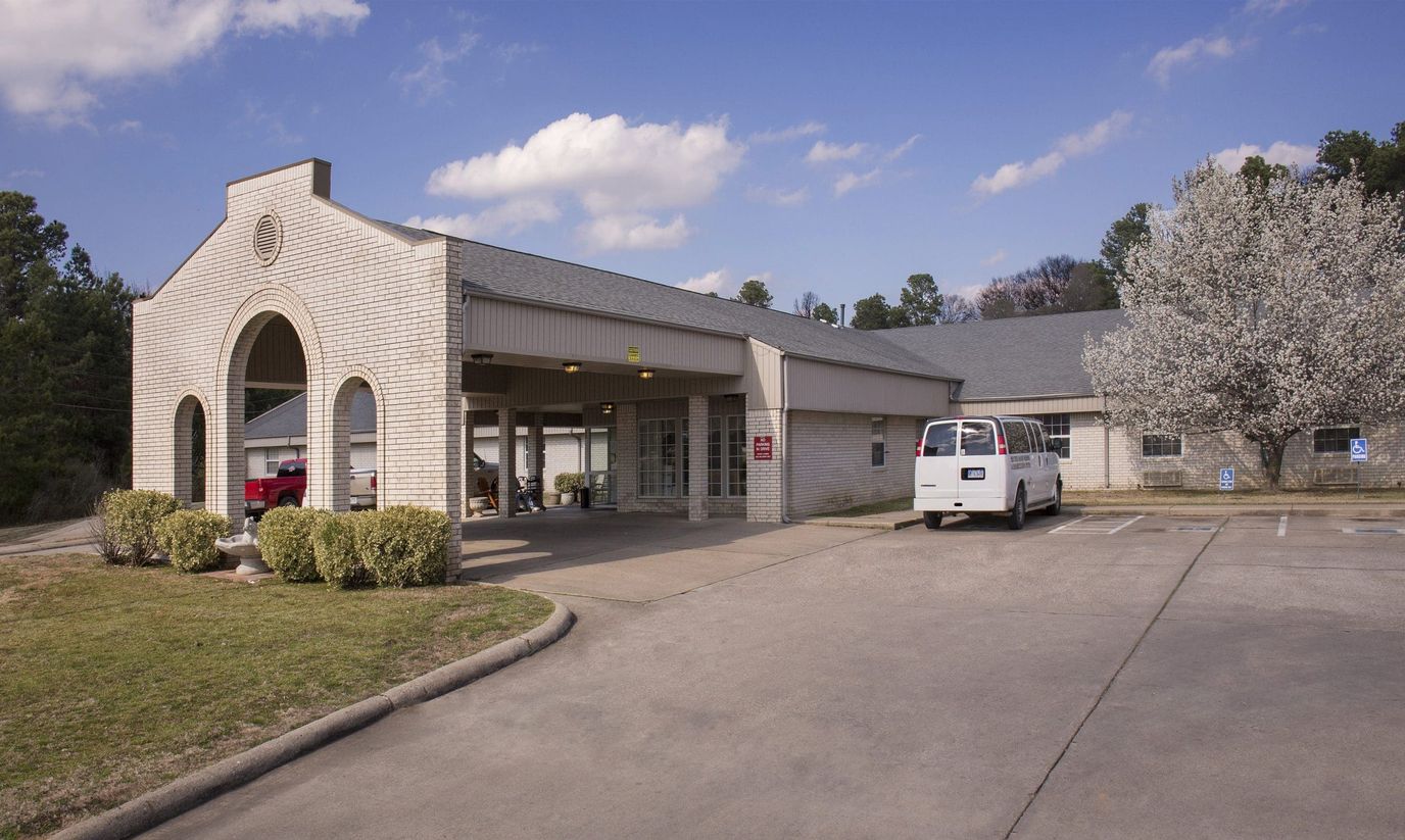 Exterior view of a senior living facility with a parking area