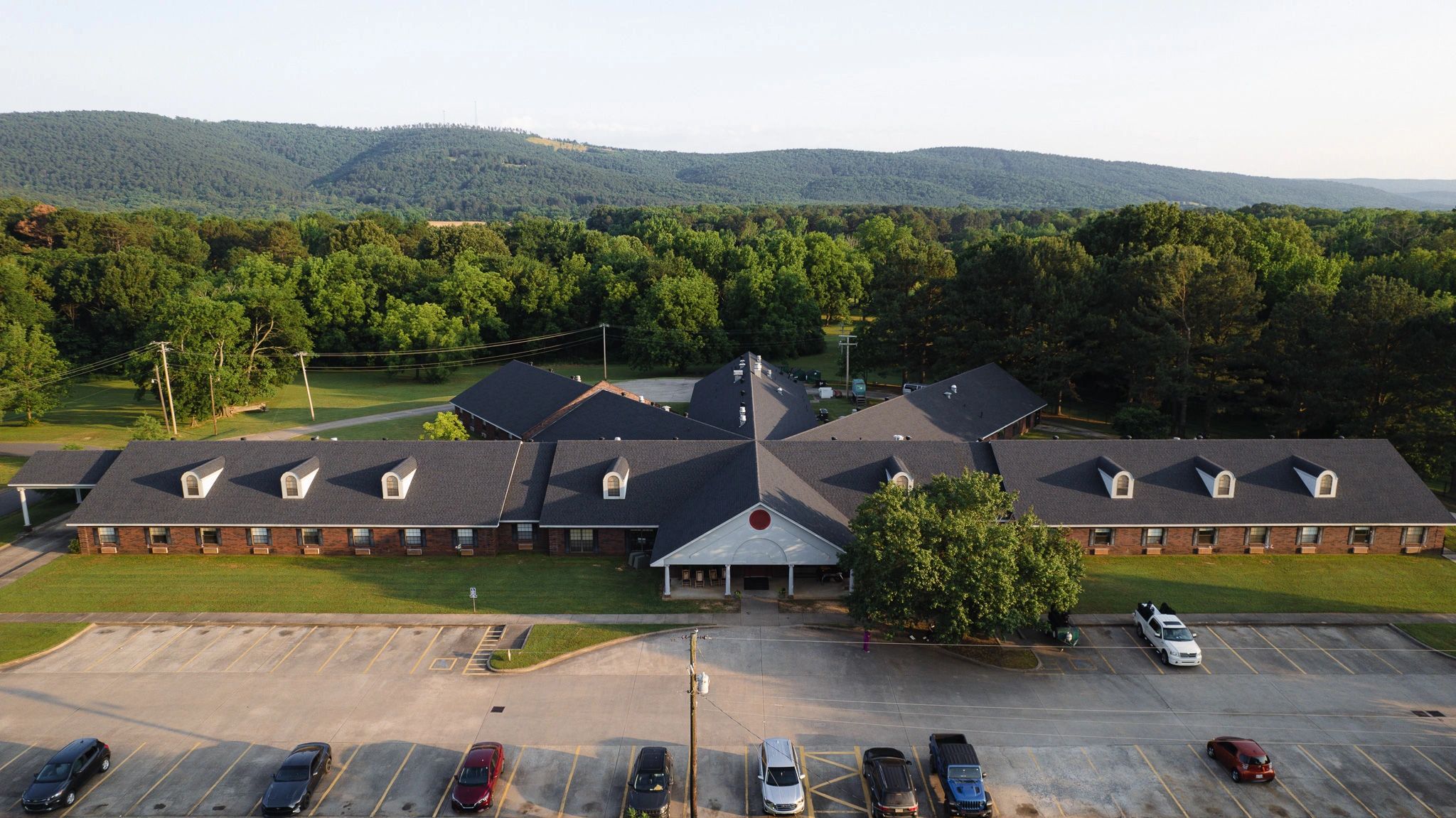 Aerial view of a senior living facility surrounded by trees