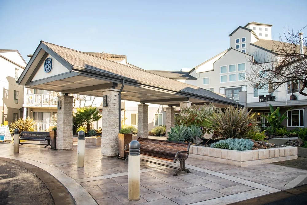 Exterior view of assisted living entrance with landscaping