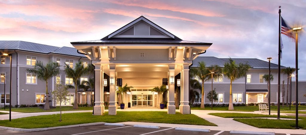 Front entrance of a senior living facility with landscaping