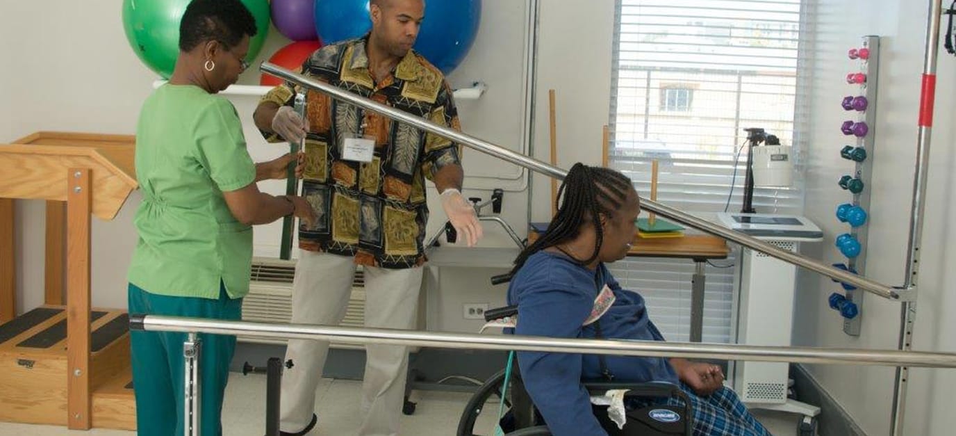 Therapist assisting resident in a rehabilitation session