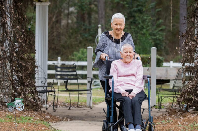 Two residents enjoying the outdoor garden area