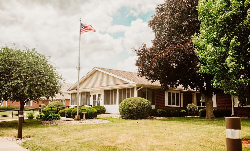 Exterior view of a senior living facility with landscaping