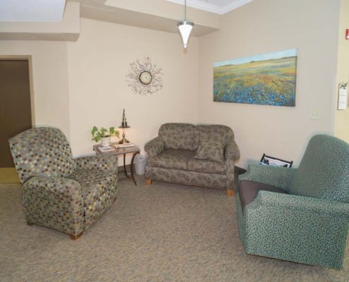 Cozy seating area with patterned chairs and wall art