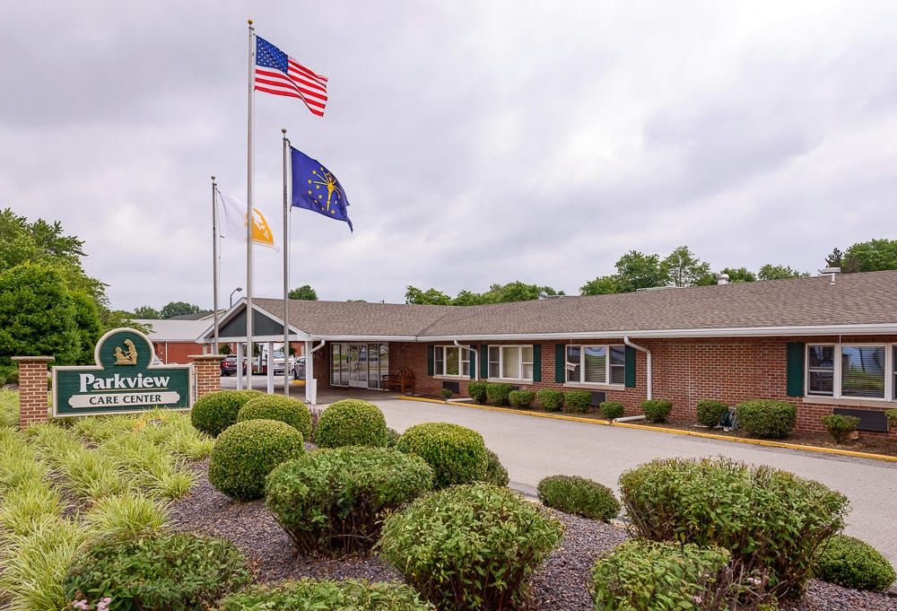 Exterior of Parkview Care Center with flags and landscaping