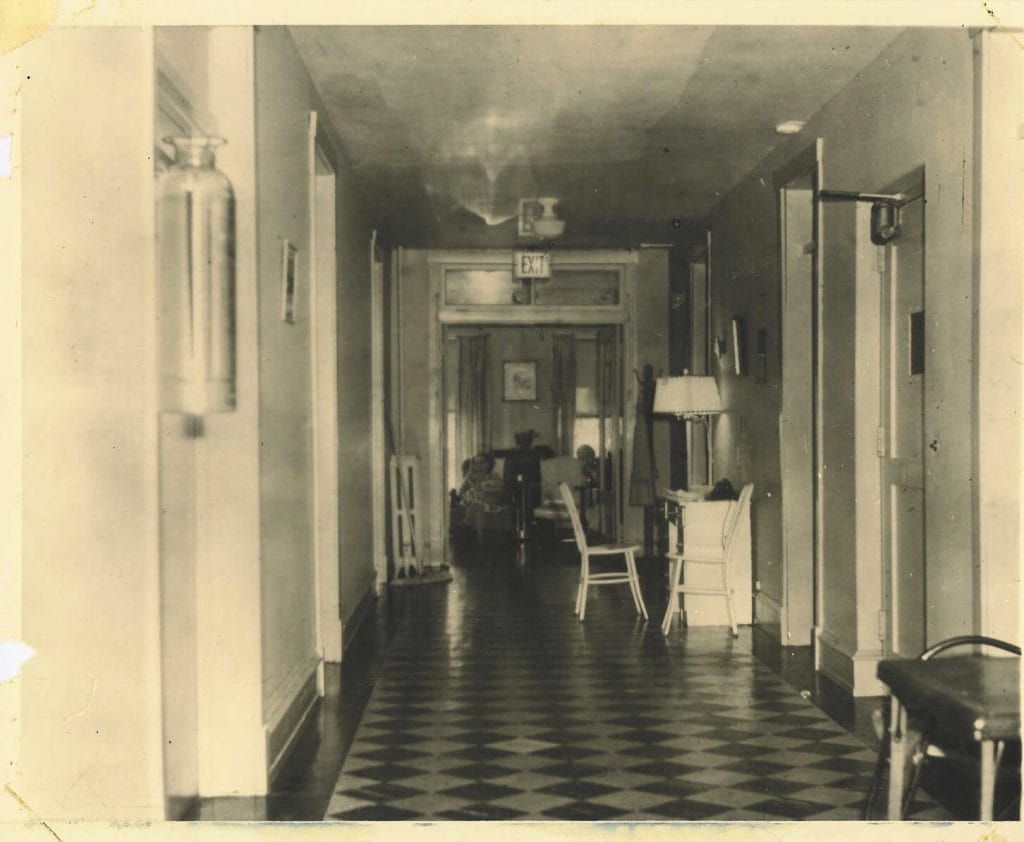 Long hallway with chairs and exit sign