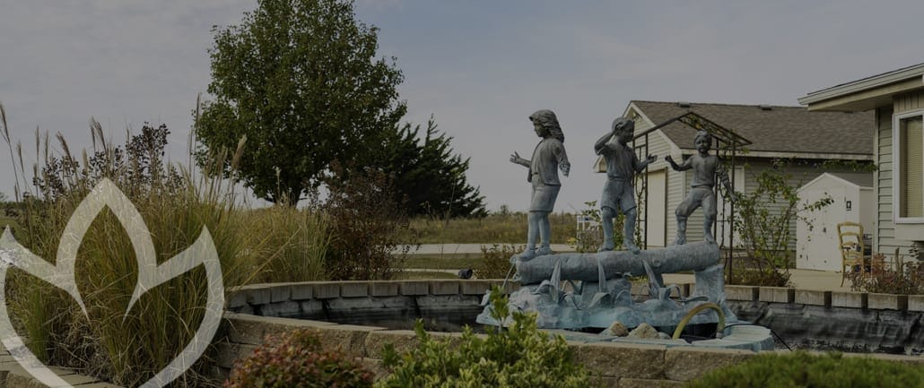 Outdoor sculpture near the facility with greenery
