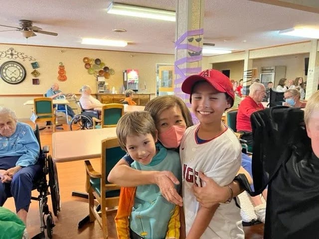 Residents interacting with children in a common area