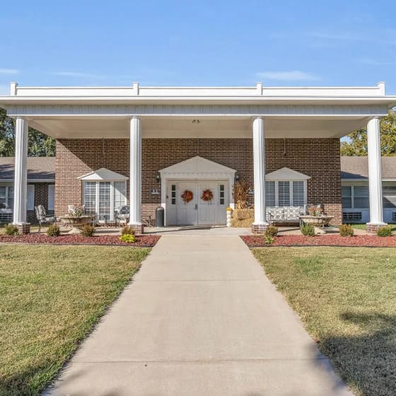 Front entrance of a senior living facility with landscaped path