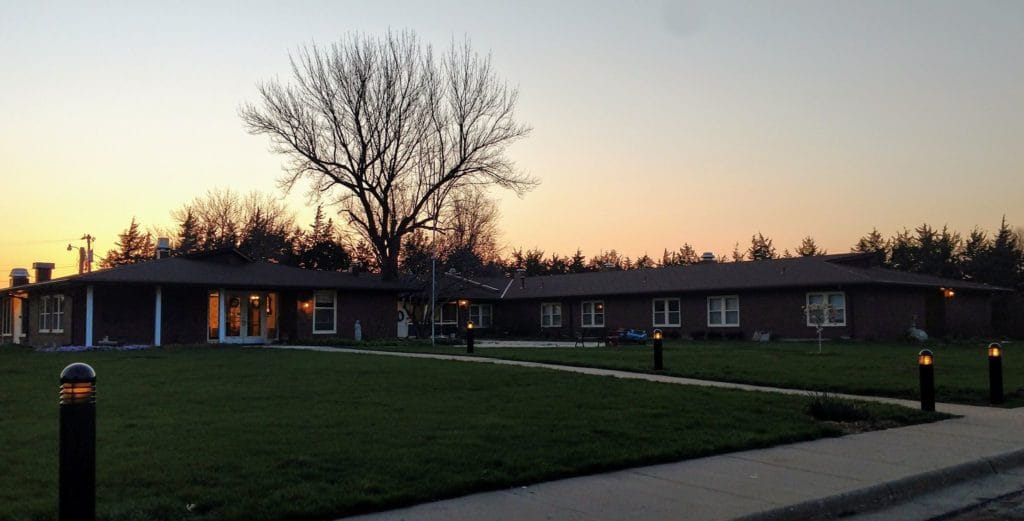 Exterior view of a nursing home at sunset