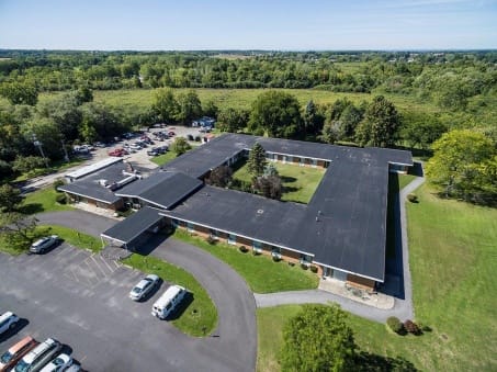 Aerial view of a senior living facility surrounded by greenery