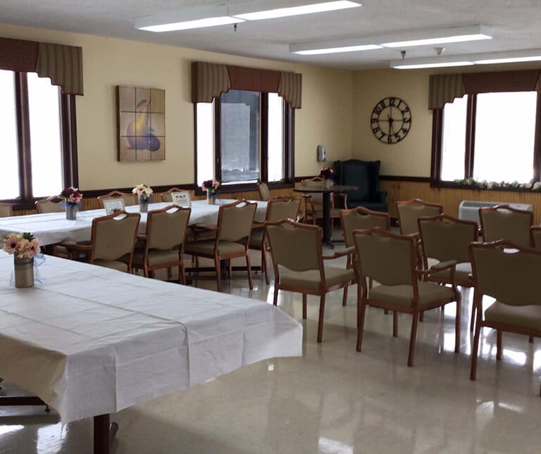 Bright common area with tables and chairs arranged