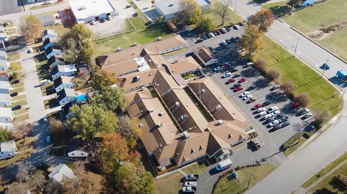 Aerial view of a senior living facility with parking area