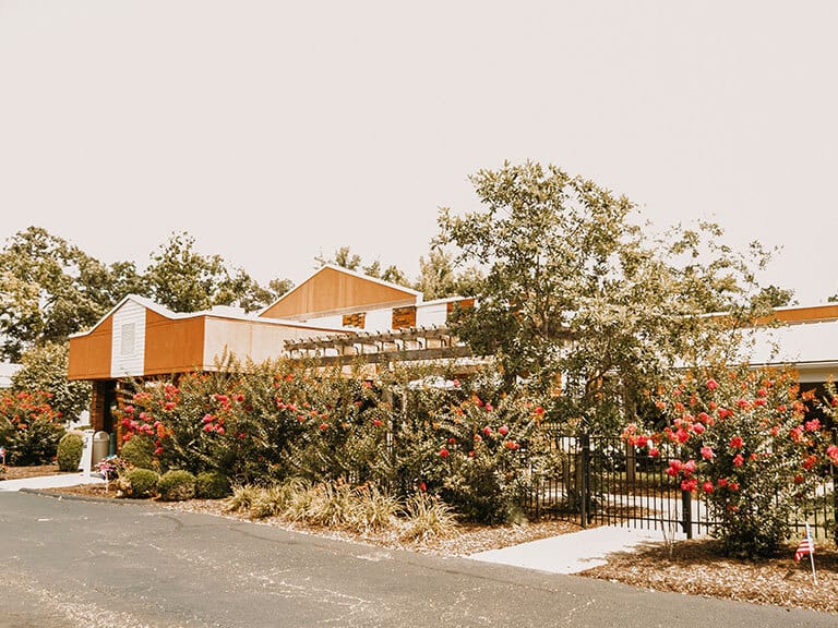 Exterior view of a senior living facility with landscaping