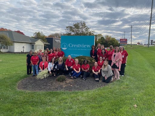 Staff gathered outside the Crestview facility sign