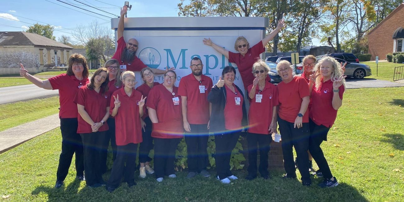 Staff members celebrating outside the facility.