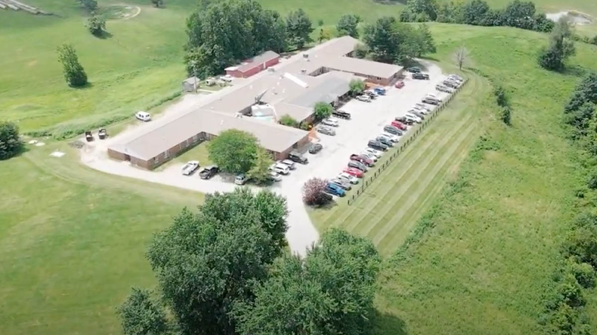 Aerial view of a senior living facility with parking area