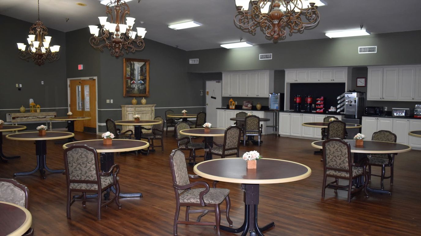 Bright dining room with tables and chairs for residents