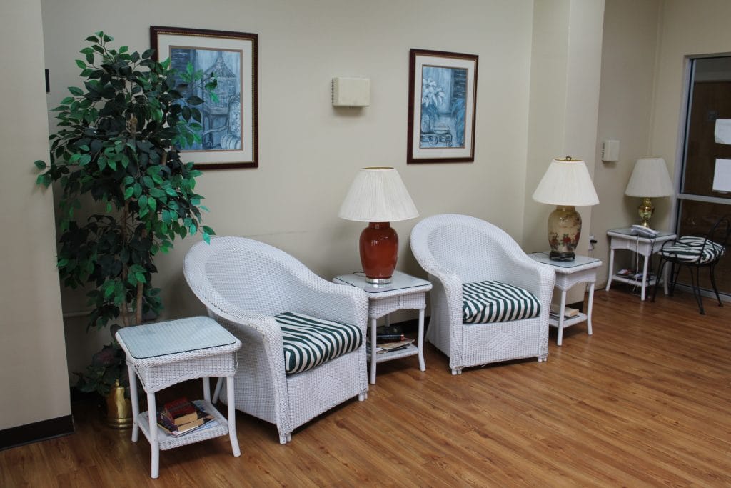 Evangeline Oaks Guest House, Nursing Home in Carencro, LA — Wicker chairs and lamps in a cozy waiting area