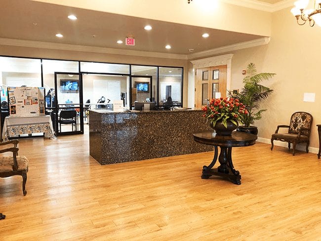 Interior lobby of a senior living facility with reception area